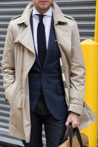 Layer trench coat over a suit